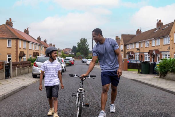 istock Learning to Ride a Bike with Dad 1555741588