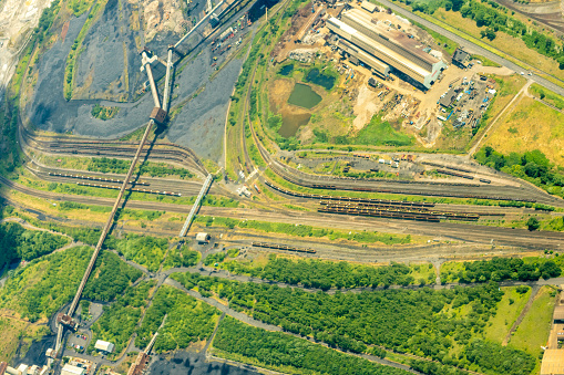 Maple Ridge, Canada - May 16, 2021: Red warning lights flash as CN 8810 heads east at the 225th Street level crossing in Maple Ridge. Background shows the Fraser River flowing through Metro Vancouver in springtime.