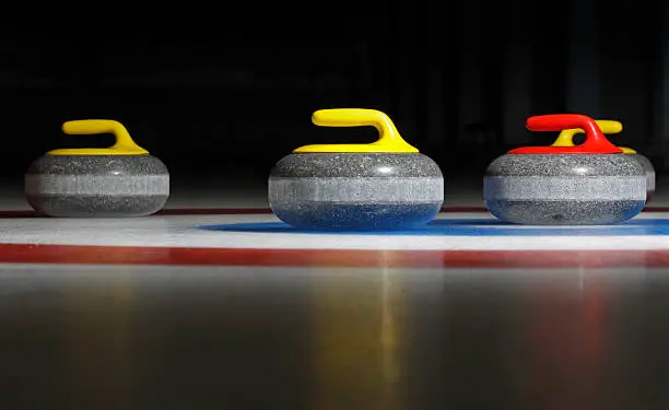 Group of four curling stones in the rings.