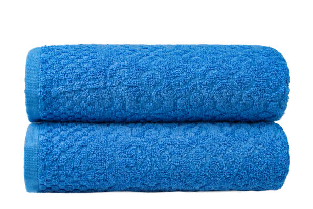 istock multicolored terry towels, rolled up and stacked on the table 1555778977