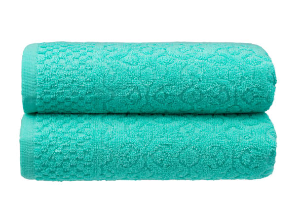 istock multicolored terry towels, rolled up and stacked on the table 1555785596