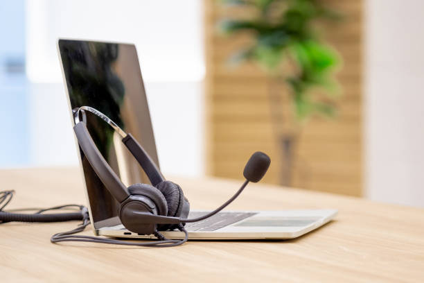 istock Headset and customer support equipment at call center service. 1555794955