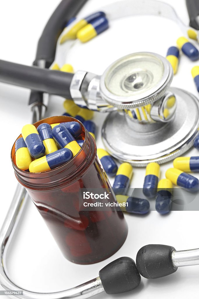 Medical Stethoscope and Capsule Perspective of Medical Stethoscope and Capsule on white background for Healthy Concept (selective focus at Pillbox) Blue Stock Photo