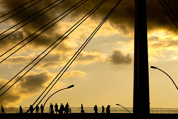 istock Silhouettes of People on Bridge at Twilight 155579894