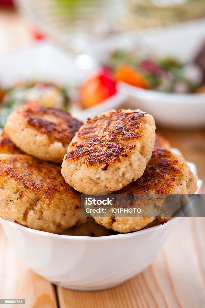 bowl of salad (radishes, tomatoes, parsley, eggs), meat katlety abundance of food on kitchen wooden table on napkin and fork with bowl of salad (radishes, tomatoes, parsley, eggs), meat katlety (pork, beef, lamb) Breakfast Stock Photo