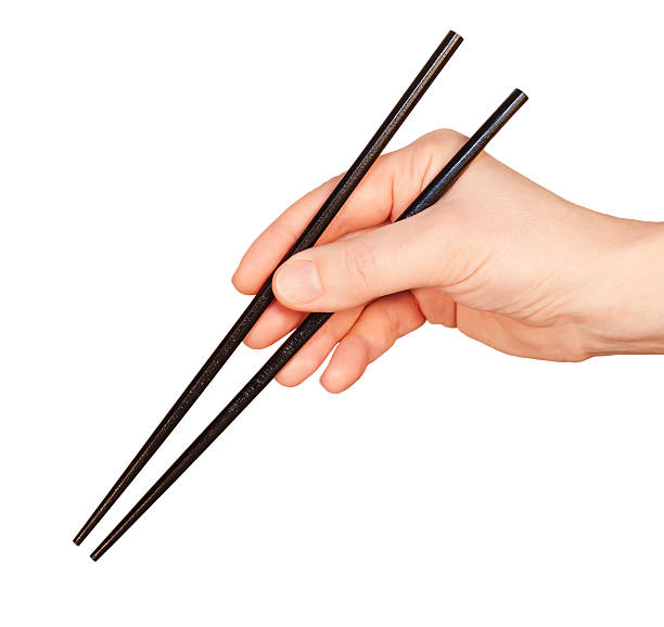Hand with chopsticks stock photo