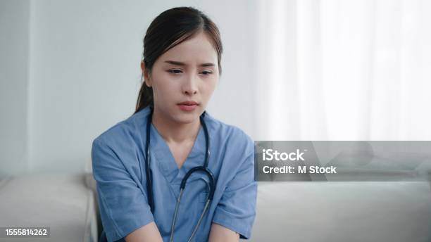 Tired Depressed Young Asian Woman Nurse Suffer After Hard Working Exhausted Sad Woman Doctor Feels Burnout Stress Physician Burnout Stock Photo - Download Image Now