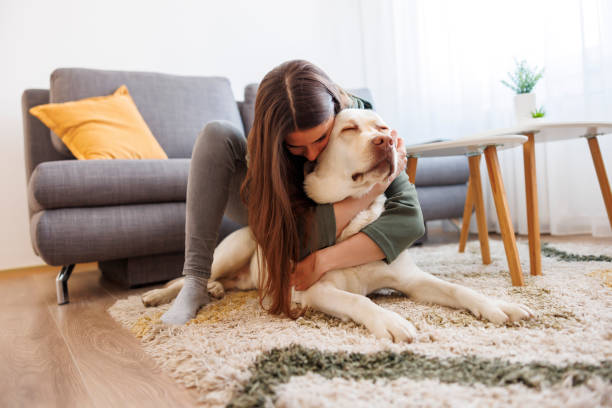 istock Woman cuddling and hugging her pet dog 1555815350