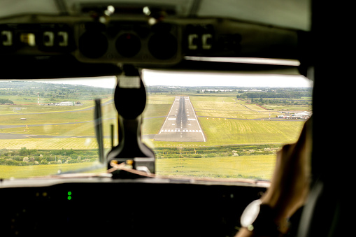 An aircraft landing or taking off from an airport tarmac runway.