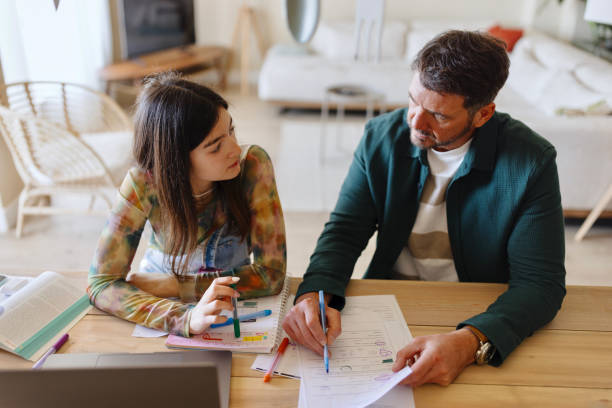 istock Father and daughter studying together 1555836409