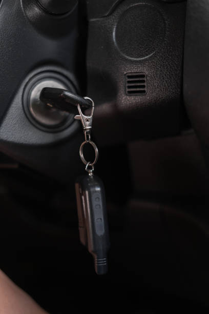 istock Car key at the keyhole, close-up. Start the car 1555850918