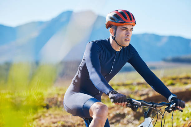 istock Fitness, countryside or man cycling on a mountain bike for training, cardio workout or exercise outdoors. Serious, healthy biker or sports athlete riding a bike on a path for wellness or challenge 1555856449