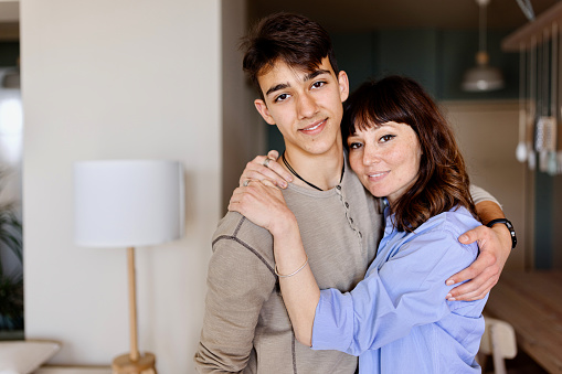 Close-up of a mother and her teenage son at home