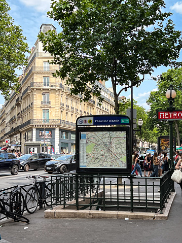 Paris, France - June 27, 2023: Street view in Paris of a Metro Station. Bicycles line the street next to the station.