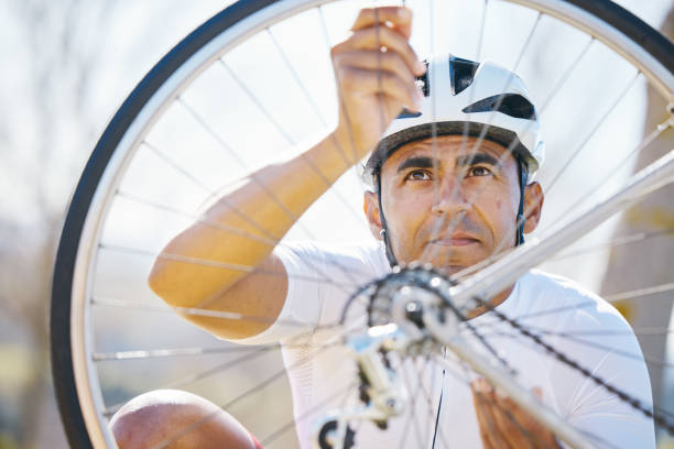 istock Fixing, bicycle and a man outdoor with wheel puncture or problem while cycling. Bike, hands and a sports person, cyclist or athlete check for maintenance, safety or repair on broken or flat tyre 1555859410