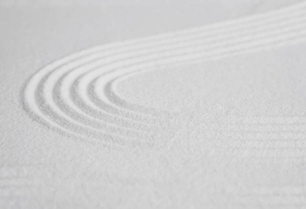 istock Zen garden with line pattern on white sand in Japanese style, Sand texture surface with wave parallel lines,Background banner for Meditation,Zen like concept,Simplicity Day 1555867051
