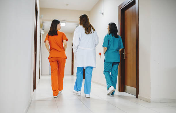 istock Three female medics walking along hospital corridor 1555870291