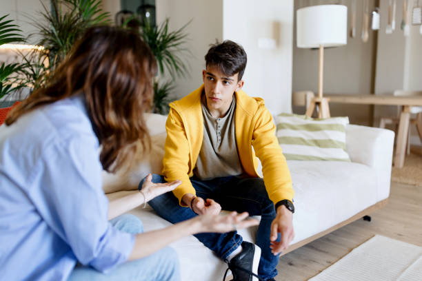 istock Mother having a discussion with her son at home 1555874025