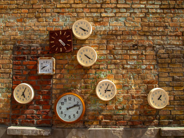 istock Round clocks hanging on the brick wall 1555877263