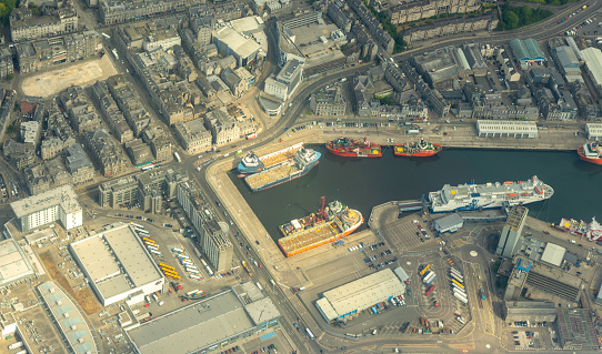 A large British harbour / port to allow ships to be anchored or to come in and drop off or load goods to be distributed across the world.