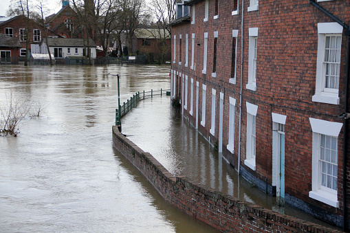 Flooded terrace houses in the town of Shrewsbury, as River Seven bursts it’s banks and overflows into streets and houses, an indication of climate change and Global warming having a very personal and damaging effect on homeowners.