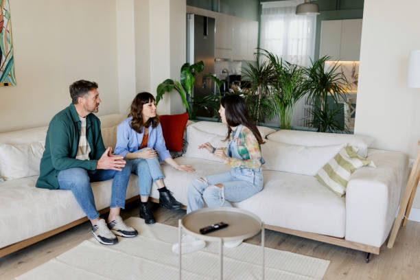 istock Young girl talking about something with her parents 1555886623