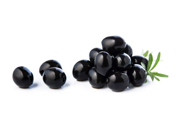 istock Black olives with leaves on white backgrounds. 1555911665