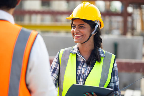 istock Asian indian woman engineering worker shaking hands on business cooperation agreement. Successful hand shaking after good deal Heavy Industry Manufacturing Factory. Prefabricated concrete walls 1555914492