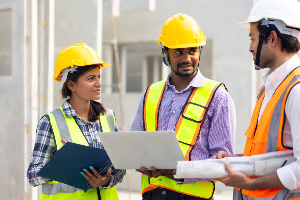 istock Professional Mechanical Engineer team Working on Personal laptop computer at Prefabricated concrete factory Heavy industrial. Product quality Inspection. Unity and teamwork concept 1555916245