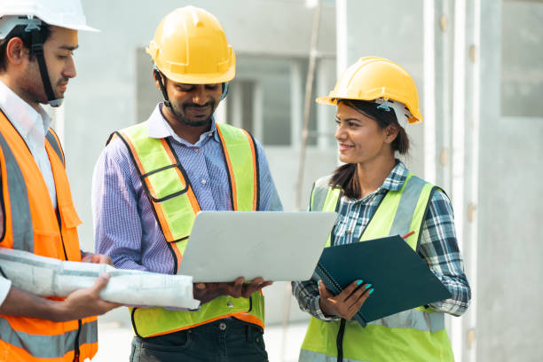 istock Professional Mechanical Engineer team Working on Personal laptop computer at Prefabricated concrete factory Heavy industrial. Product quality Inspection. Unity and teamwork concept 1555916264