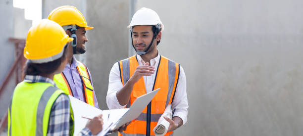 istock Professional Mechanical Engineer team Working on Personal laptop computer at Prefabricated concrete factory Heavy industrial. Product quality Inspection. Unity and teamwork concept 1555916266
