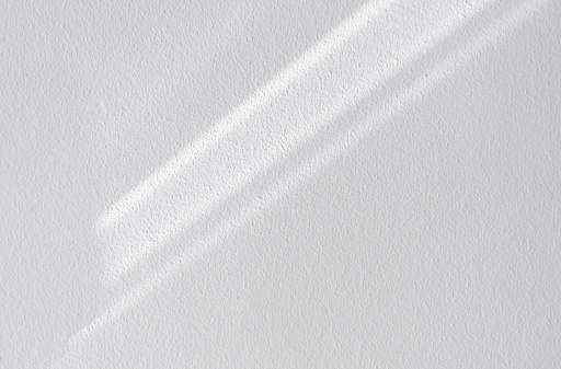 White wall concrete texture with abstract drop diagonal shadow. Sunlight overlay on white plaster paint on concrete floor,Light effect for Monochrome photo, mock up, poster, wall art, design presentation