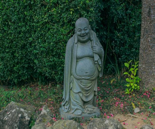 istock Statue of a buddha smiling 1555924288
