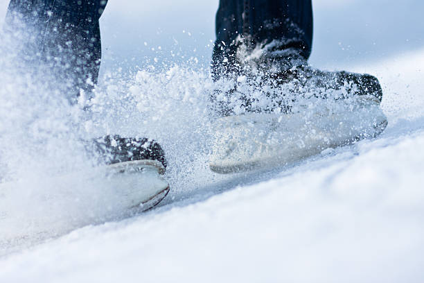 istock Two breaking ice skates with flying snow 155592634