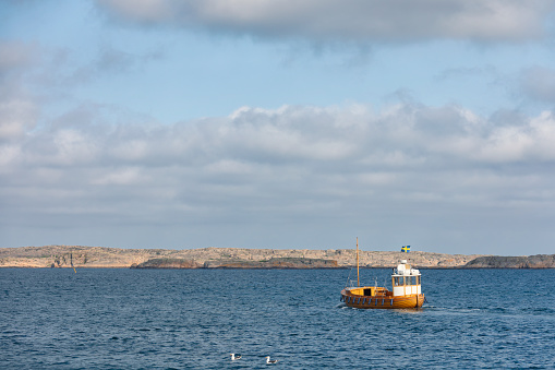 A wooden boat heading out to sea near Smögen on the coast of Bohuslän, Sweden.