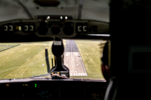 An aircraft landing or taking off from an airport tarmac runway.