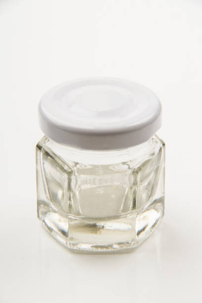 istock Small empty transparent glass vial on white background 1555946882