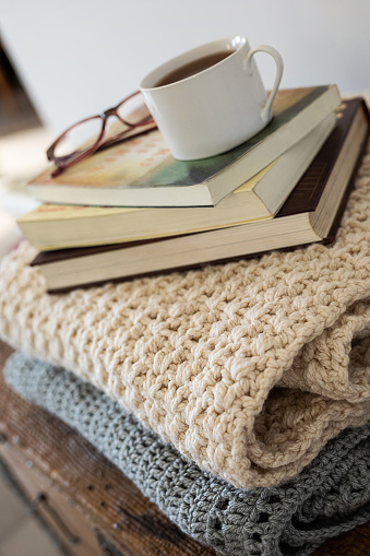 Stack of knitted blankets, books and cup of tea - Buenos Aires - Argentina