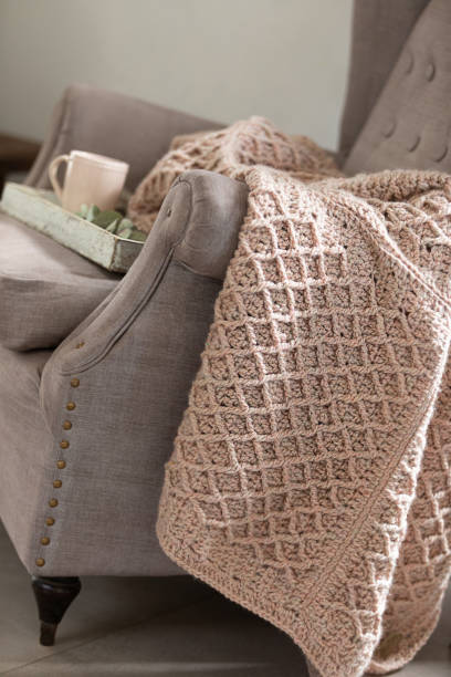 istock Woven blanket on an armchair 1555947841