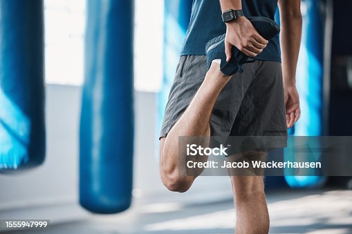 istock Back, fitness and stretching with a sports man in the gym getting ready for a workout or training routine. Exercise, health and warm up with a male athlete in preparation of a workout for wellness 1555947999