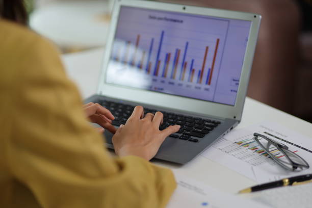 istock Businesswoman working with laptop on desk typing and analyzing financial data. 1555964268