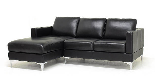 Leather Sofa Sectional style sofa (2 seat sofa plus chaise) in black leather with metal legs. Isolated on white. chaise longue stock pictures, royalty-free photos & images
