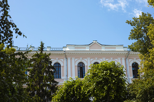 An old historical building behind trees