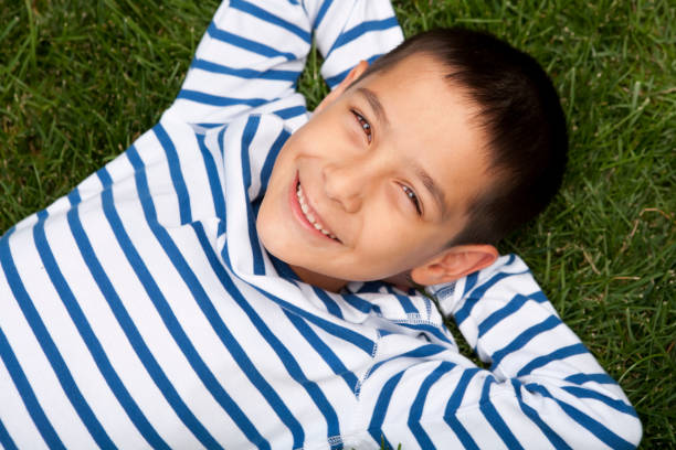 istock Young boy laying in the grass 155597049