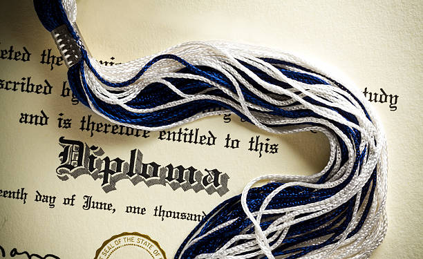 High School Diploma Diploma and tassel shot from above.  Concept for graduation. diploma stock pictures, royalty-free photos & images