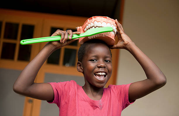 istock African girl with toothbrush and teeth 155597498