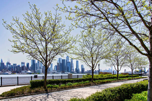 istock Hudson River from Days Point park with trees in New Jersey towards lower Manhattan 1555976458