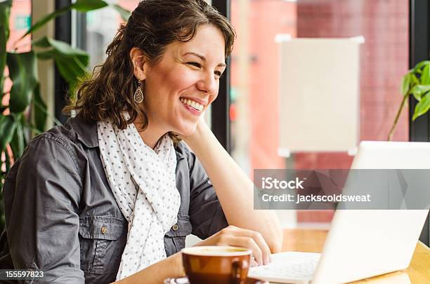 Woman Video Chatting In A Coffee Shop Stock Photo - Download Image Now - Coffee Shop, Laptop, Watching