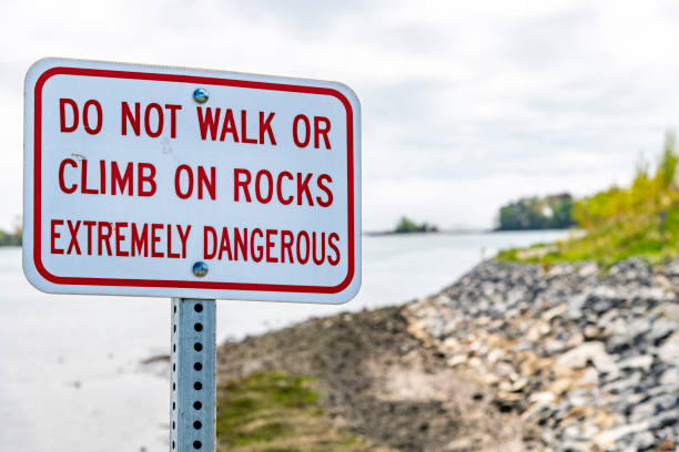 istock White sign with red letters warning not to climb or walk on rocks 1555980833