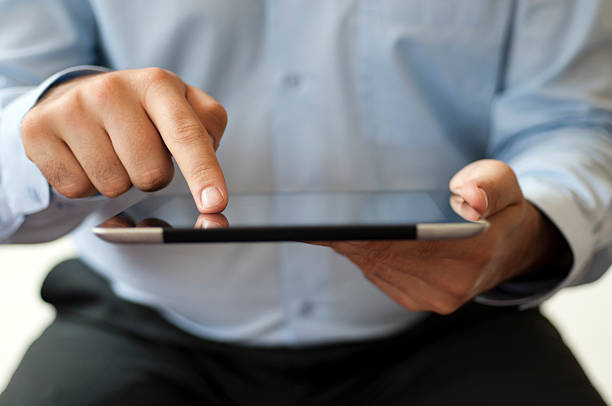 Close up of businessman using digital tablet stock photo